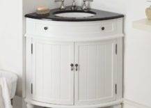 Rounded white vanity with a black countertop and swing-open cabinet doors.