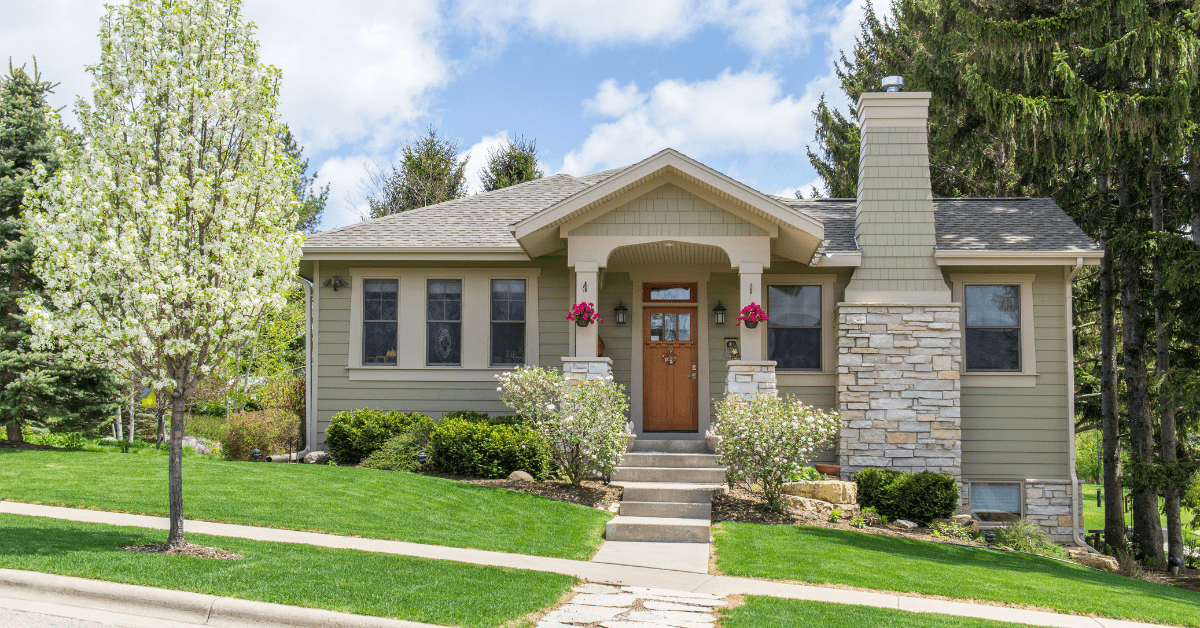 Small Craftsman style house with pillared awning atop the entrance door.